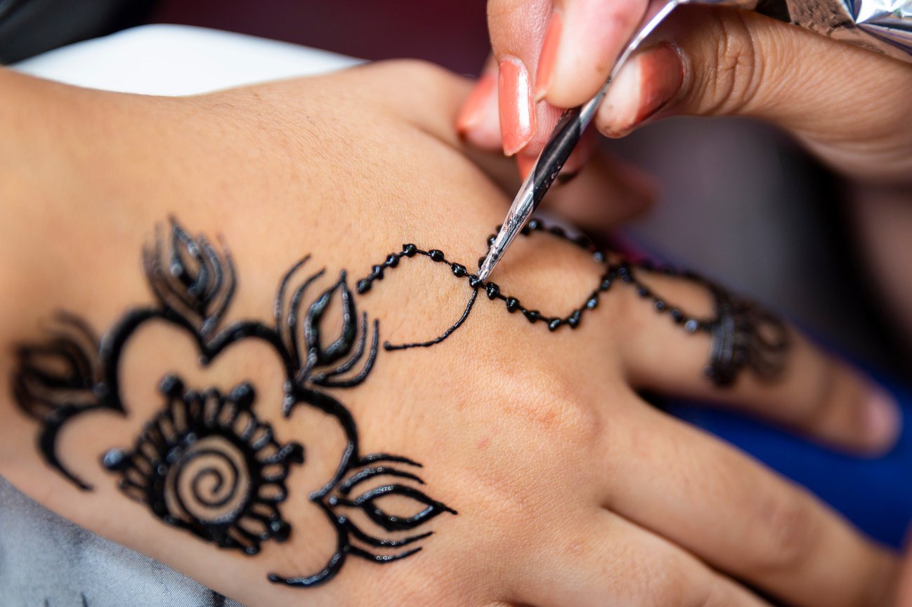 Applying henna tattoo